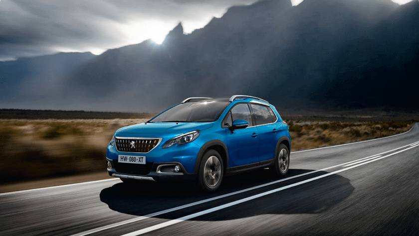 A blue Peugeot 208 break on the road